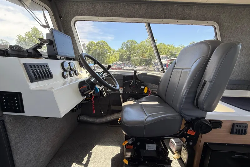 Slide: The Image of Interior of a 2018 Thunder Jet Pilot 26' boat with steering wheel and control panel. - 7