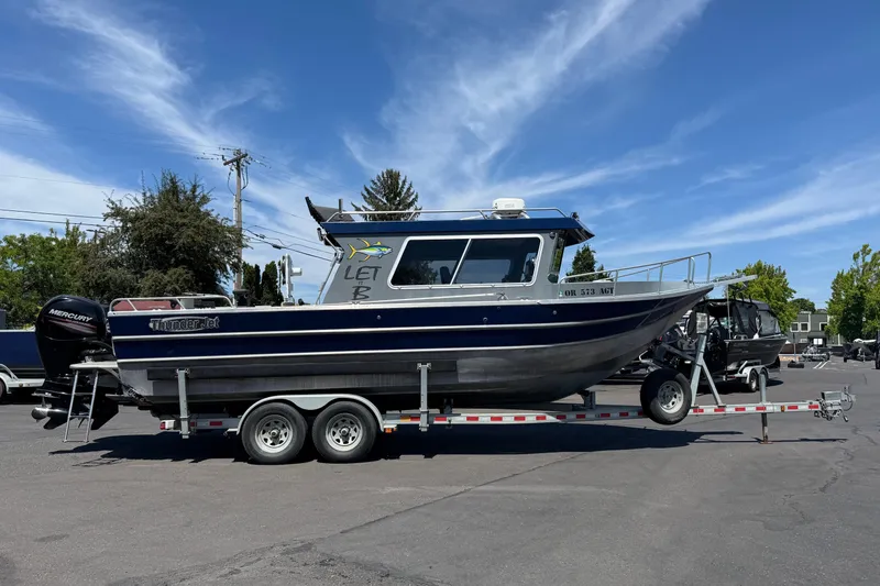 The Image of 2018 Thunder Jet Pilot 26' boat on trailer, parked outdoors under a clear blue sky. - 1