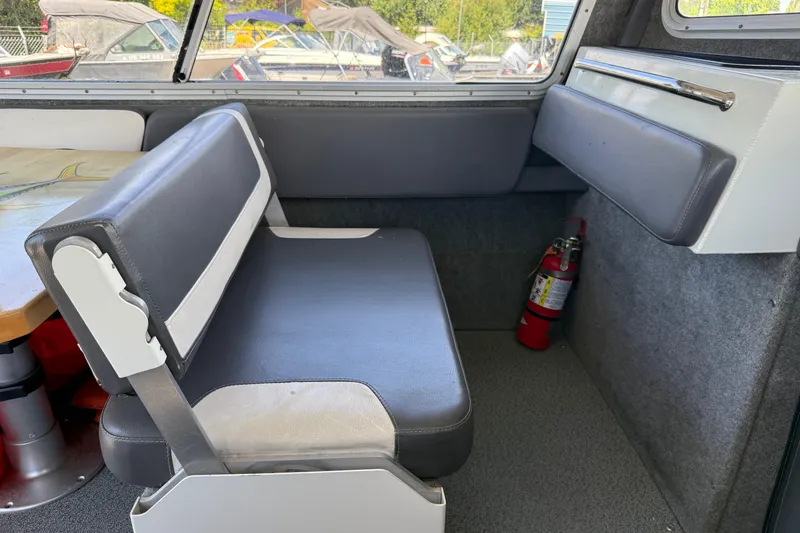 Slide: The Image of Interior of a 2018 Thunder Jet Pilot 26' boat with seating and fire extinguisher. - 9