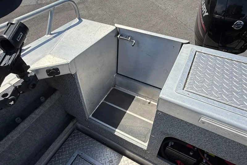 Slide: The Image of 2018 Thunder Jet Pilot 26' boat interior with storage compartment and Mercury engine. - 25