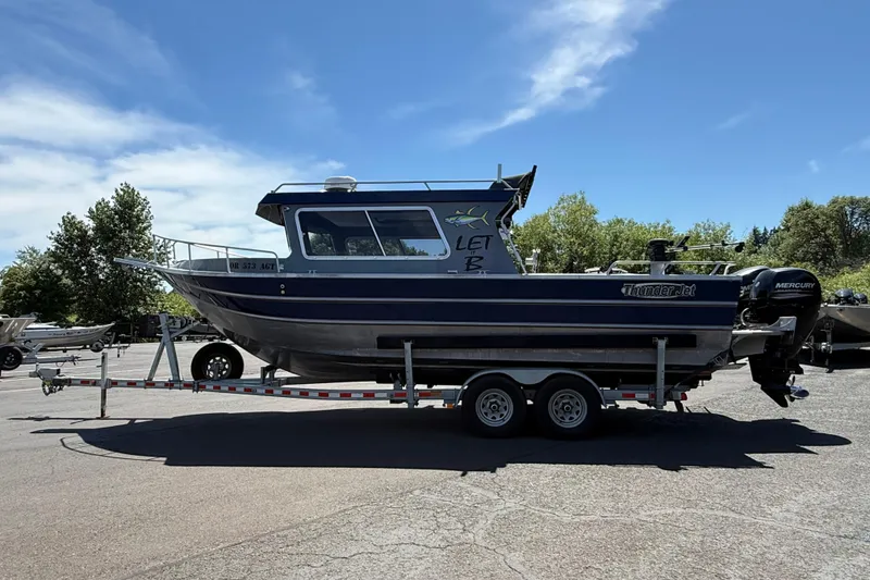 Slide: The Image of 2018 Thunder Jet Pilot 26' boat on trailer, parked outdoors under clear sky. - 3