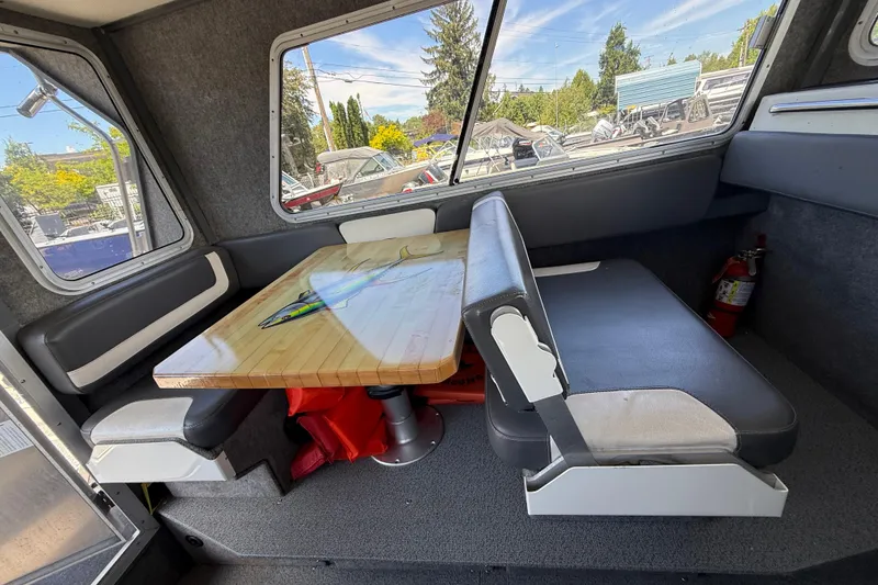 Slide: The Image of Interior of a 2018 Thunder Jet Pilot 26' boat with seating and table. - 11