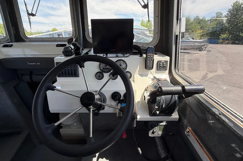 Slide: The Image of Interior cockpit of 2018 Thunder Jet Pilot 26' boat with steering wheel and controls. - 8