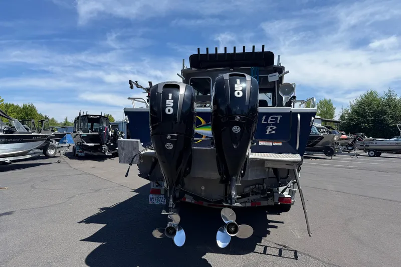 Slide: The Image of 2018 Thunder Jet Pilot 26' boat with dual 150 horsepower engines in a marina. - 4