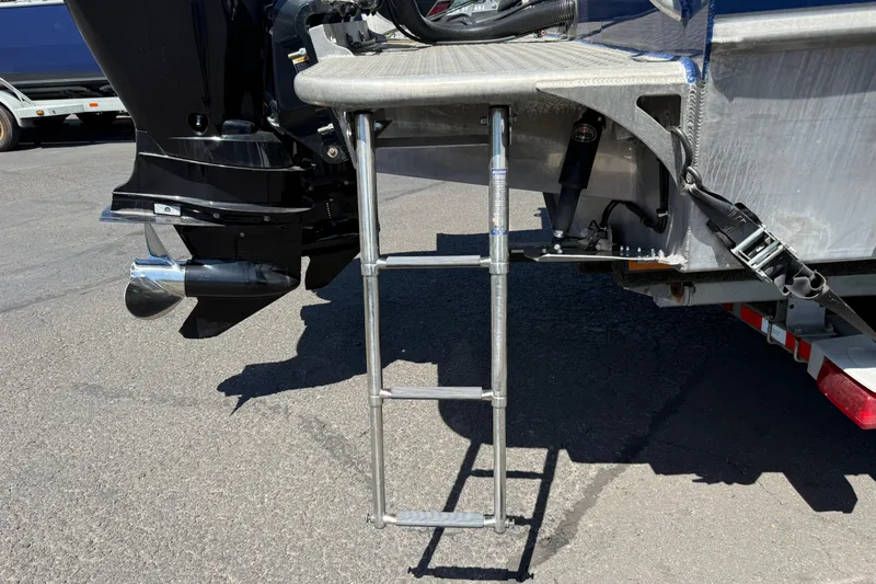 Slide: The Image of Rear view of a 2018 Thunder Jet Pilot 26' boat with a metal ladder and outboard motor. - 26