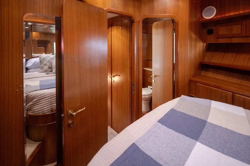 Slide: The Image of Luxurious wooden interior of a 2000 Symbol 50 Pilothouse yacht bedroom. - 16