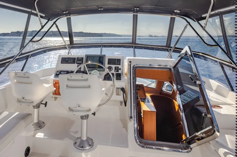 Slide: The Image of Pilothouse interior of 2000 Symbol 50 yacht with dual seats and ocean view. - 17