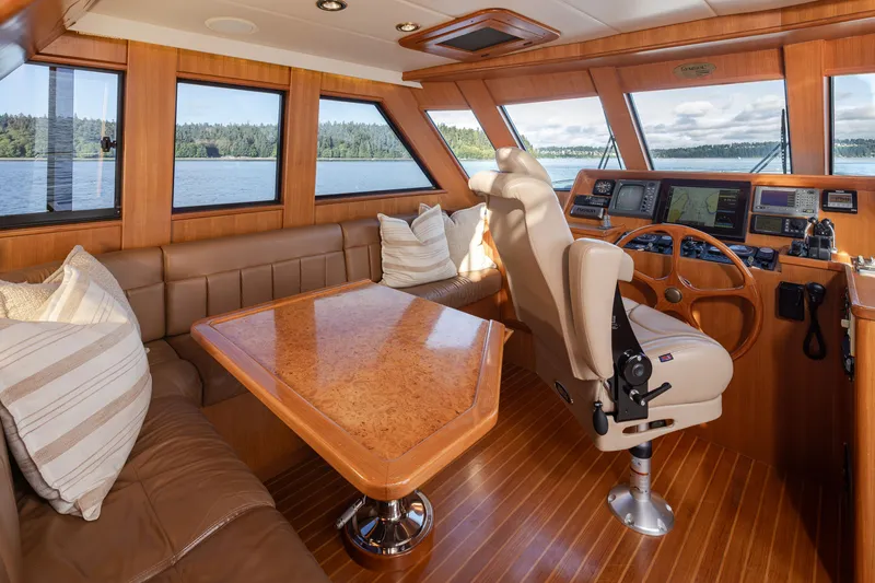 Slide: The Image of Luxurious interior of 2000 Symbol 50 Pilothouse yacht with leather seating and navigation controls. - 8