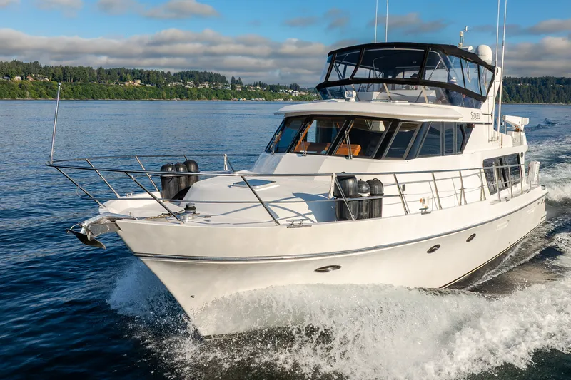 Slide: The Image of Luxurious 2000 Symbol 50 Pilothouse yacht cruising on a serene lake. - 29