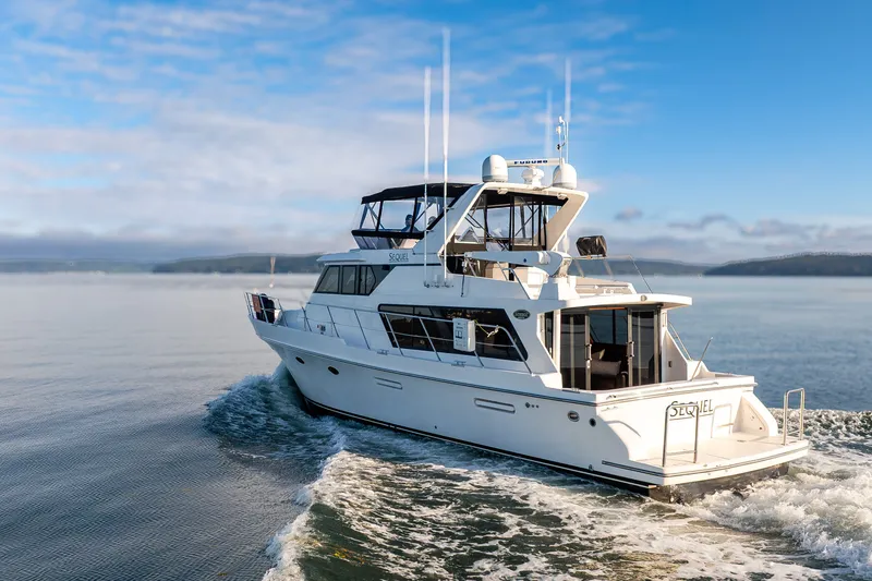 Slide: The Image of Symbol 50 Pilothouse yacht cruising on calm waters under a clear blue sky. - 26