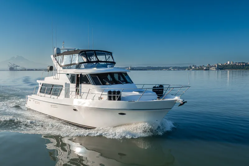Slide: The Image of Luxury Symbol 50 Pilothouse yacht cruising on calm waters, 2000 model. - 25