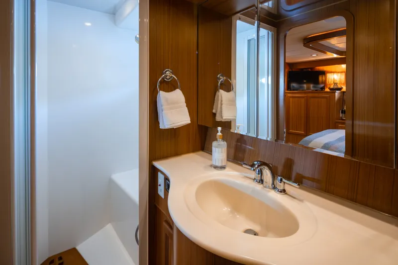 Slide: The Image of Luxurious bathroom in 2000 Symbol 50 Pilothouse yacht with modern fixtures and wooden accents. - 13