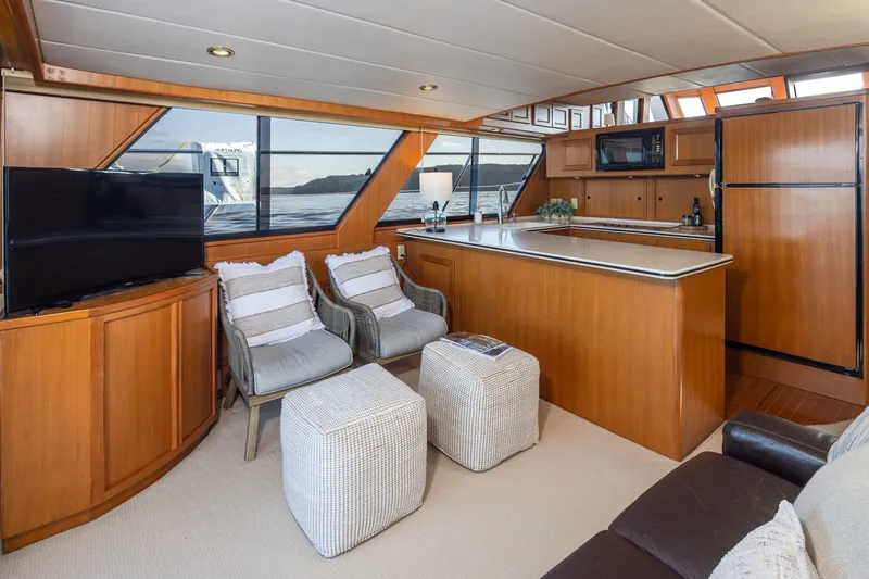 Slide: The Image of Luxurious interior of a 2000 Symbol 50 Pilothouse yacht with modern kitchen and seating area. - 3