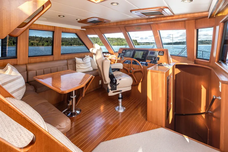 Slide: The Image of Luxurious interior of a 2000 Symbol 50 Pilothouse yacht with panoramic windows and elegant wood finishes. - 7