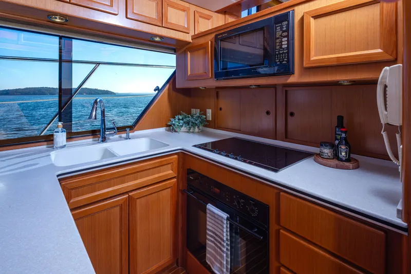 Slide: The Image of Luxurious kitchen interior on a 2000 Symbol 50 Pilothouse yacht with ocean view. - 6