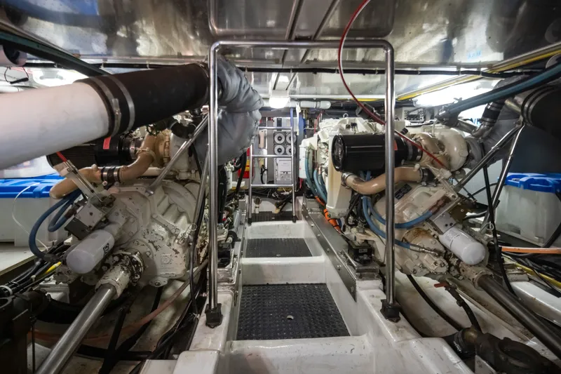 Slide: The Image of Engine room of a 2000 Symbol 50 Pilothouse yacht, showcasing dual engines and mechanical systems. - 22