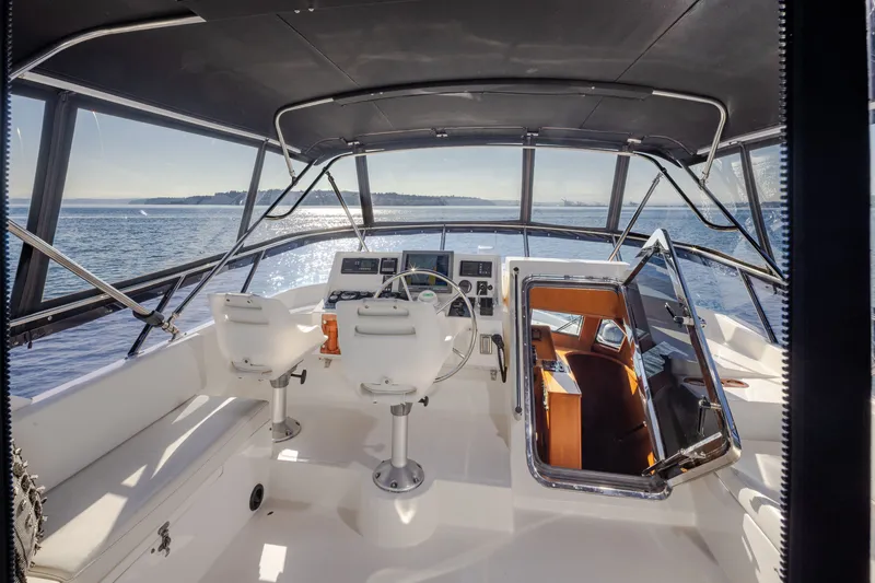 Slide: The Image of Pilothouse interior of 2000 Symbol 50 yacht, featuring dual seats and panoramic ocean view. - 18