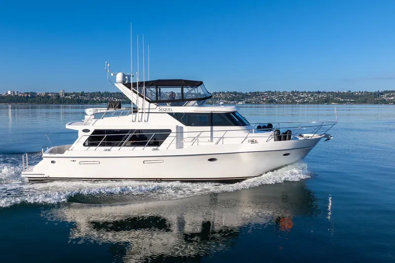 The Image of A 2000 Symbol 50 Pilothouse yacht cruising on calm waters under a clear blue sky. - 0