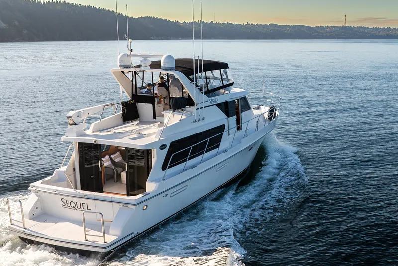 Slide: The Image of Luxury Symbol 50 Pilothouse yacht cruising on serene waters, 2000 model. - 27
