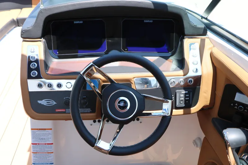 Slide: The Image of 2026 Chaparral 30 Surf boat dashboard with steering wheel and control panel. - 47
