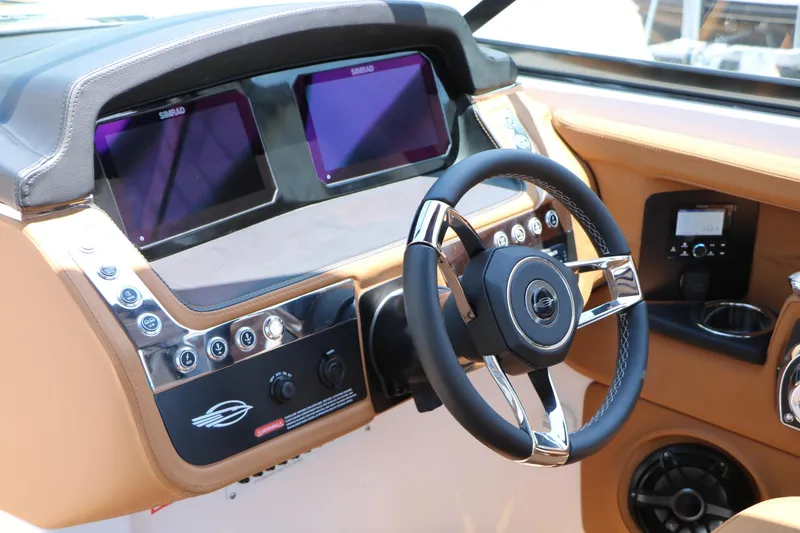 Slide: The Image of 2026 Chaparral 30 Surf boat dashboard with dual Simrad displays and modern steering wheel. - 46
