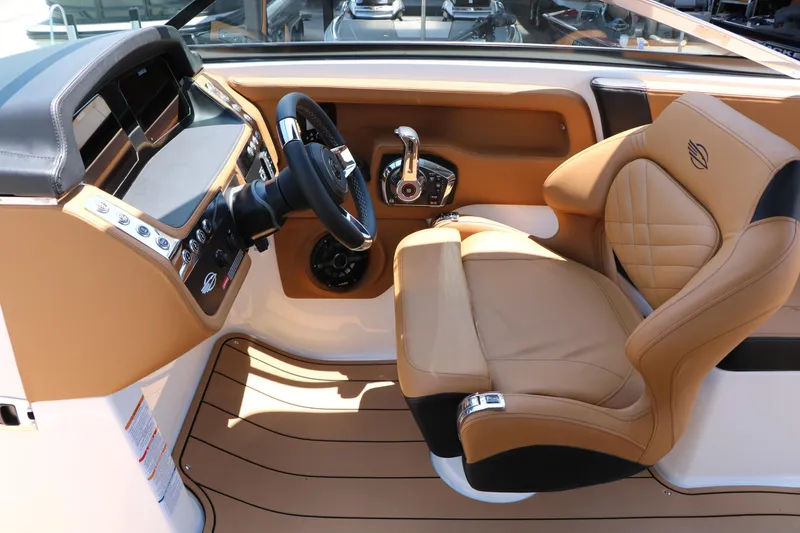 Slide: The Image of 2026 Chaparral 30 Surf boat interior with luxurious tan leather seating and modern dashboard controls. - 40