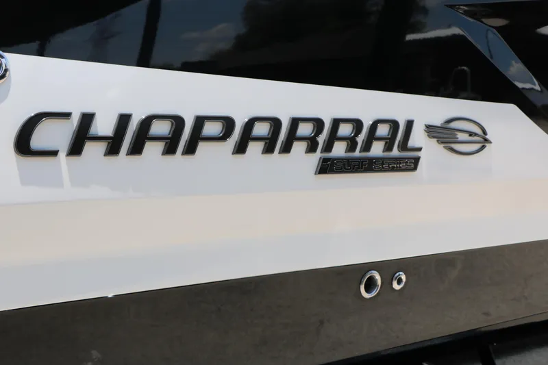 Slide: The Image of 2026 Chaparral 30 Surf boat logo on sleek black and white surface. - 9