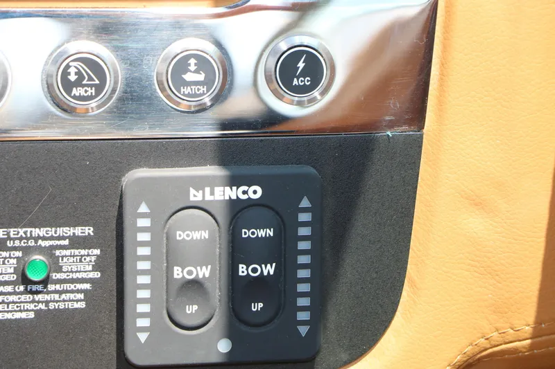 Slide: The Image of Control panel of 2026 Chaparral 30 Surf boat with Lenco trim tab switches. - 49