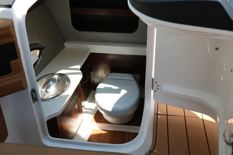 Slide: The Image of 2026 Chaparral 30 Surf boat interior with compact bathroom and sink. - 34