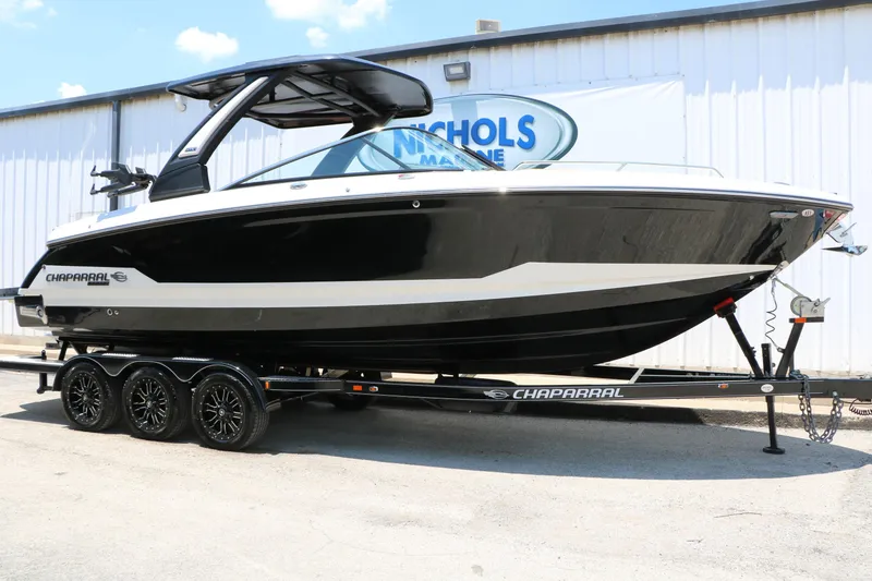 The Image of 2026 Chaparral 30 Surf boat on trailer, displayed outdoors at Nichols Marine. - 0