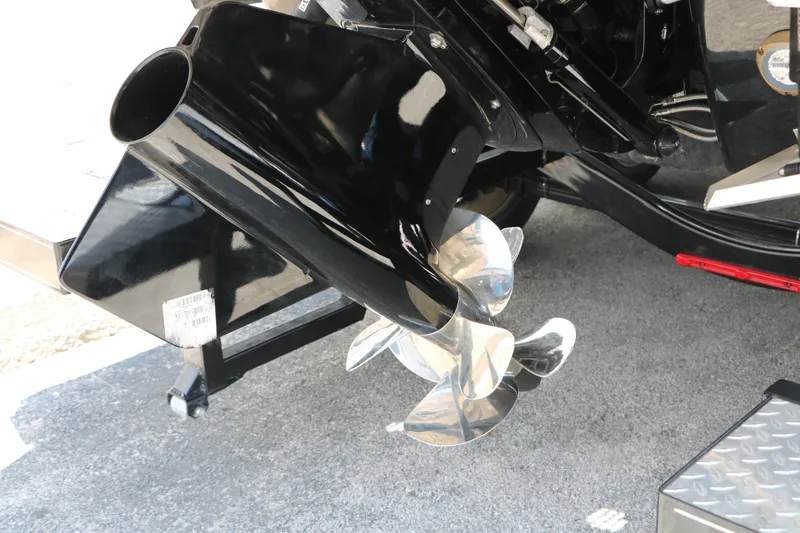 Slide: The Image of 2026 Chaparral 30 Surf boat propeller and outdrive detail on pavement. - 13