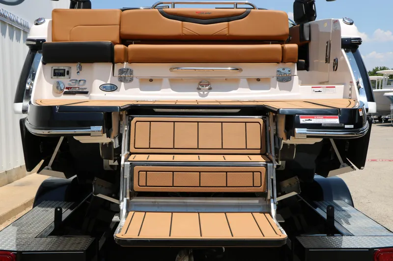 Slide: The Image of 2026 Chaparral 30 Surf boat with tan seating and swim platform. - 22