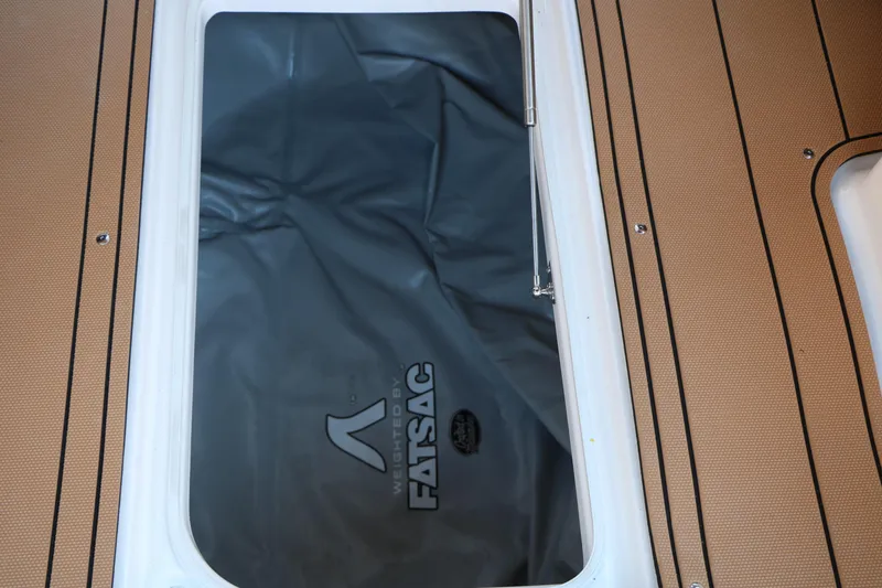 Slide: The Image of 2026 Chaparral 30 Surf boat storage compartment with FATSAC ballast bag. - 32