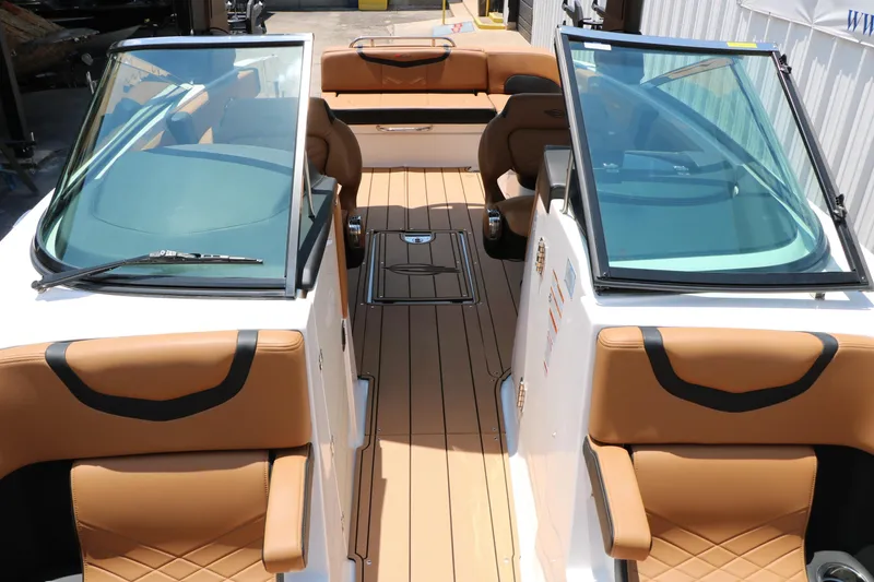 Slide: The Image of 2026 Chaparral 30 Surf boat interior with tan leather seats and sleek design. - 59