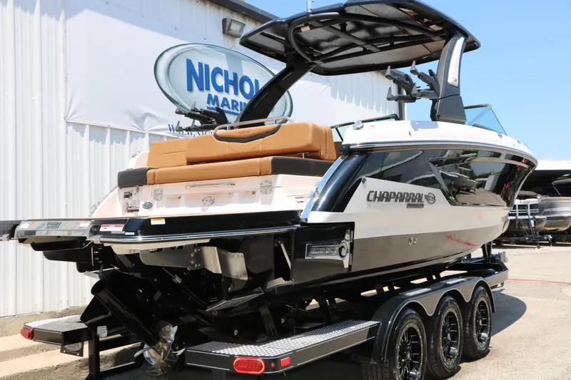 Slide: The Image of 2026 Chaparral 30 Surf boat on trailer at dealership, showcasing sleek design and modern features. - 7