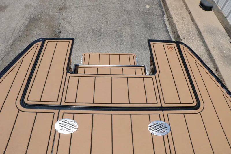 Slide: The Image of 2026 Chaparral 30 Surf boat deck with tan and black non-slip surface. - 24