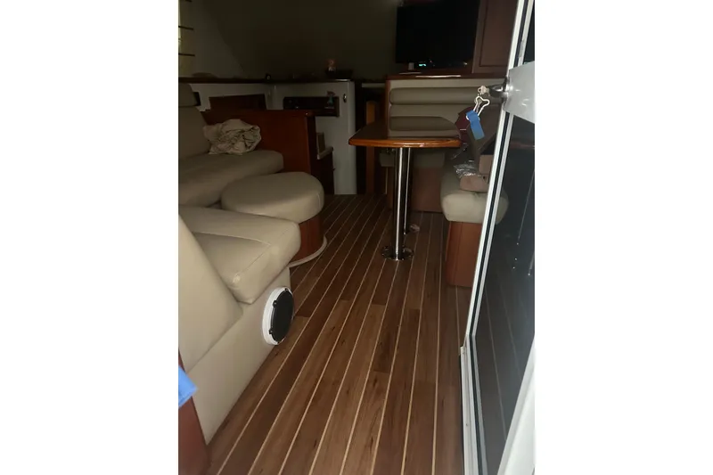 Slide: The Image of Interior of 2005 Riviera 37 Flybridge yacht with wooden flooring and beige seating. - 39