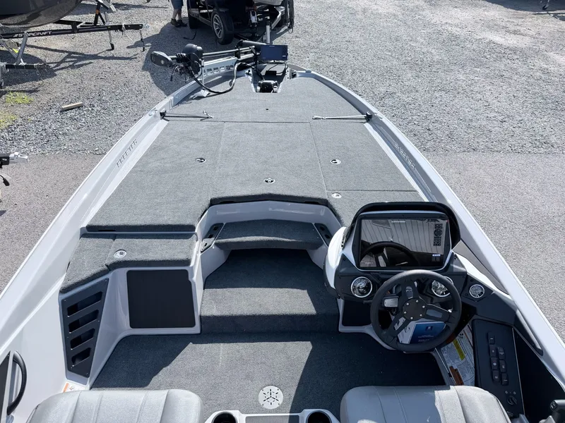 Slide: The Image of The image shows the deck of a modern boat with gray carpeting and a helm station. - 37