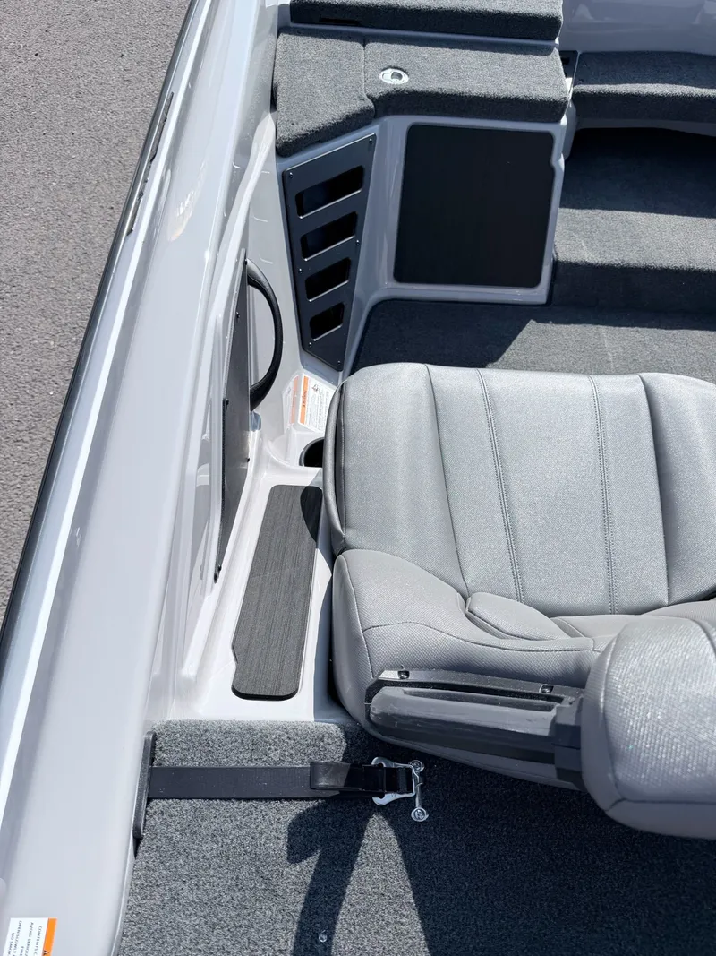 Slide: The Image of The image shows a boat interior with gray seating and carpeted flooring. - 4