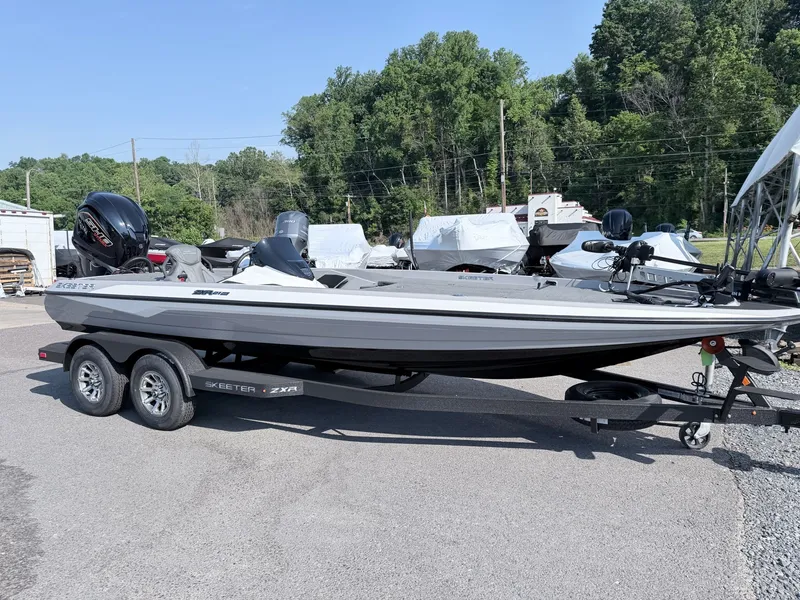 Slide: The Image of A gray Skeeter ZXR20 SE boat from 2026 is on a trailer in a parking lot. - 20