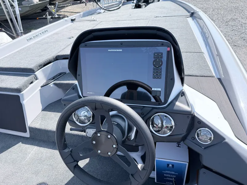 Slide: The Image of The image shows the cockpit of a Skeeter ZXR20 SE boat with a large screen and steering wheel. - 38
