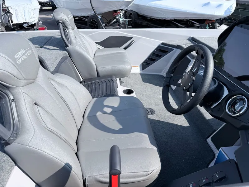 Slide: The Image of The image shows the interior of a Skeeter ZXR20 SE boat with gray seats and a steering wheel. - 3