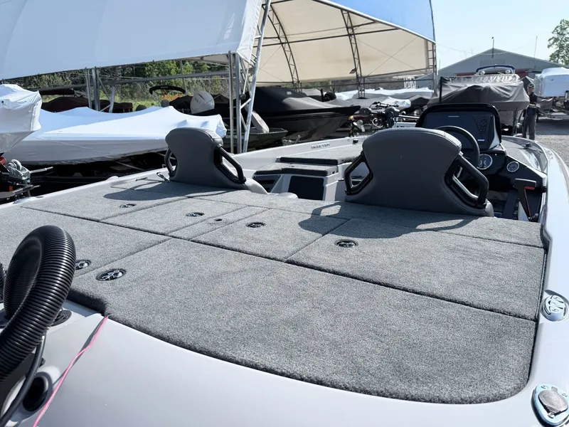 Slide: The Image of The image shows the deck of a 2026 Skeeter ZXR20 SE boat with gray carpeting. - 25