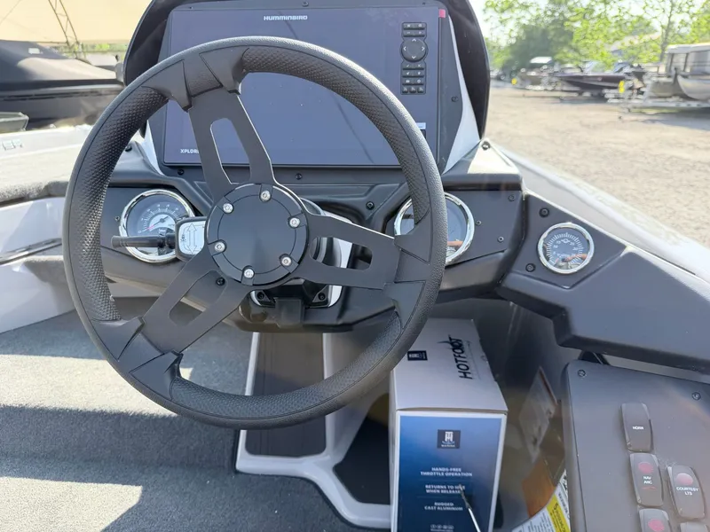 Slide: The Image of The image shows the cockpit of a Skeeter ZXR20 SE boat with a modern steering wheel and instruments. - 34