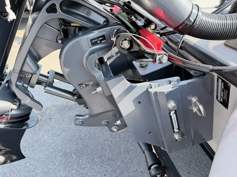 Slide: The Image of Close-up of a boat's outboard motor with gray metal components and cables. - 33
