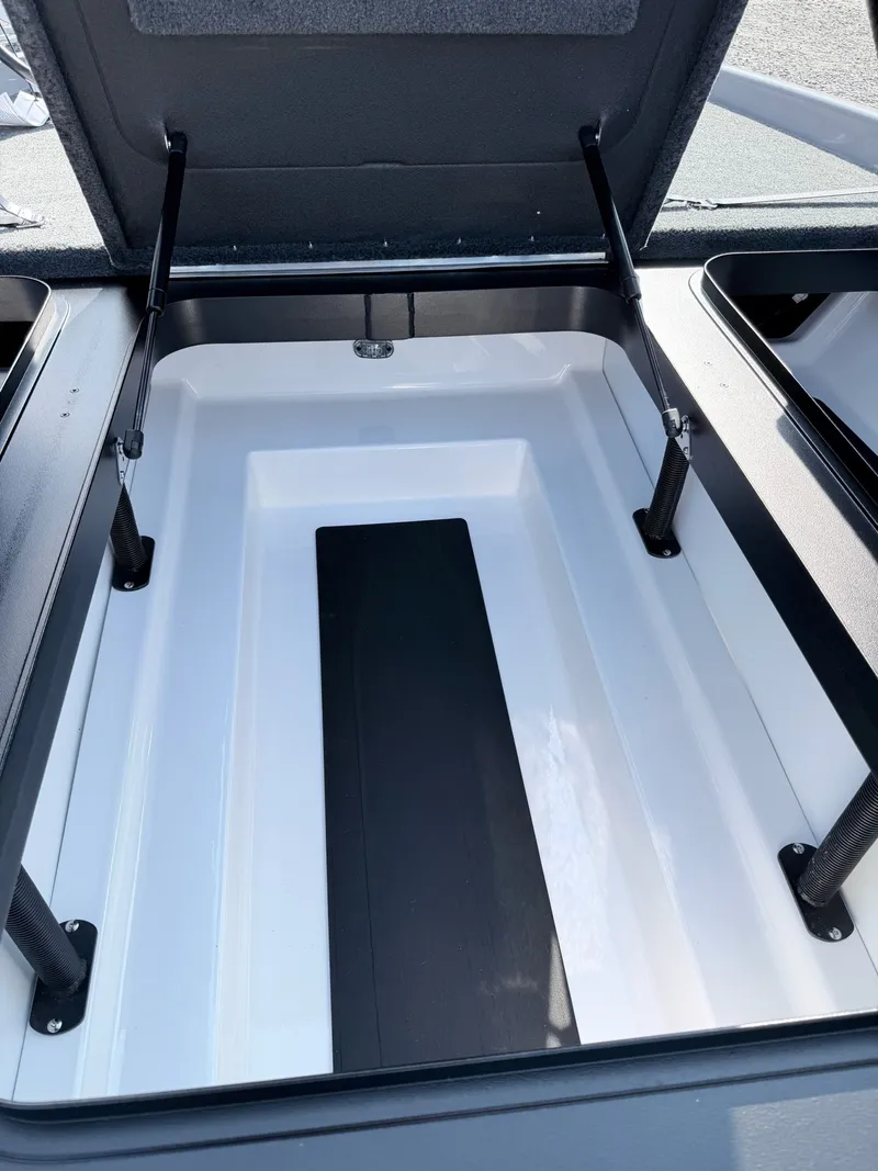 Slide: The Image of Open storage compartment in a boat with hydraulic supports and a non-slip mat. - 30