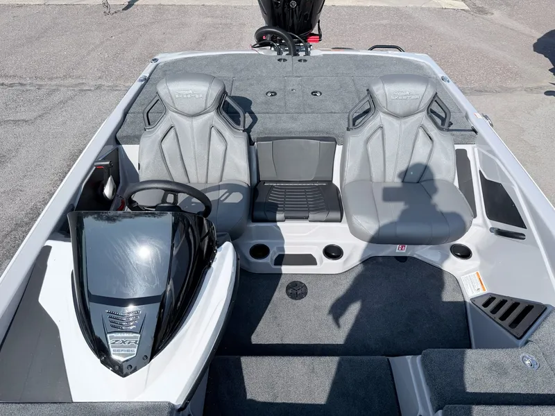 Slide: The Image of The image shows the cockpit of a Skeeter ZXR20 SE boat with gray seats and a steering wheel. - 14
