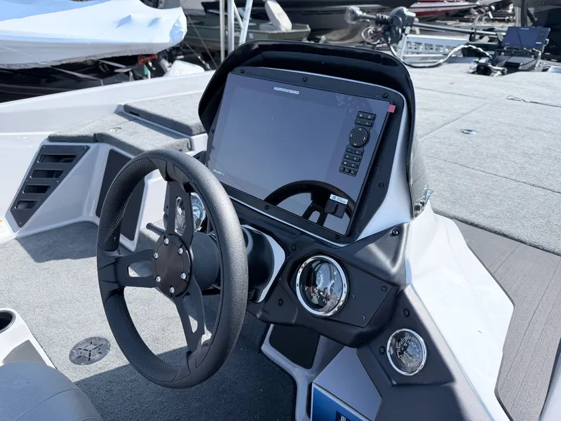 Slide: The Image of The image shows the cockpit of a Skeeter ZXR20 SE boat with modern steering and electronics. - 26
