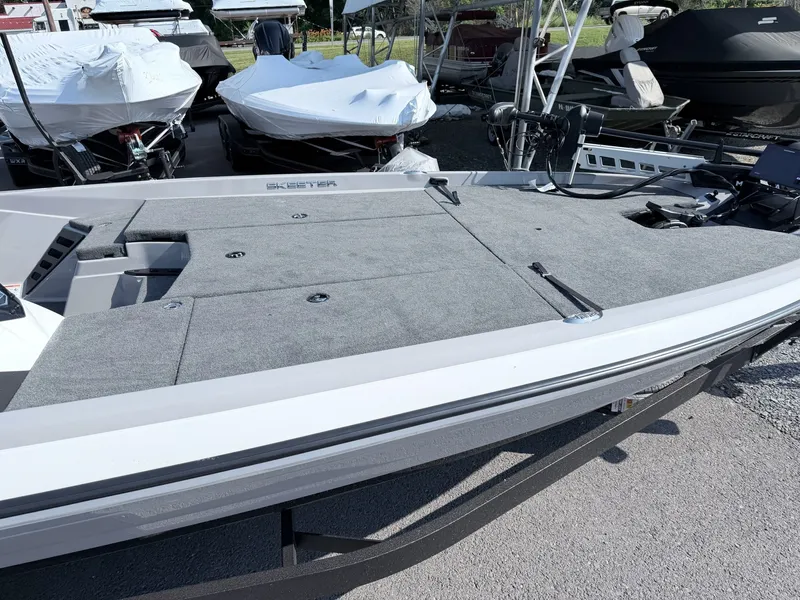 Slide: The Image of The image shows a 2026 Skeeter ZXR20 SE boat with a gray deck and black trailer. - 12