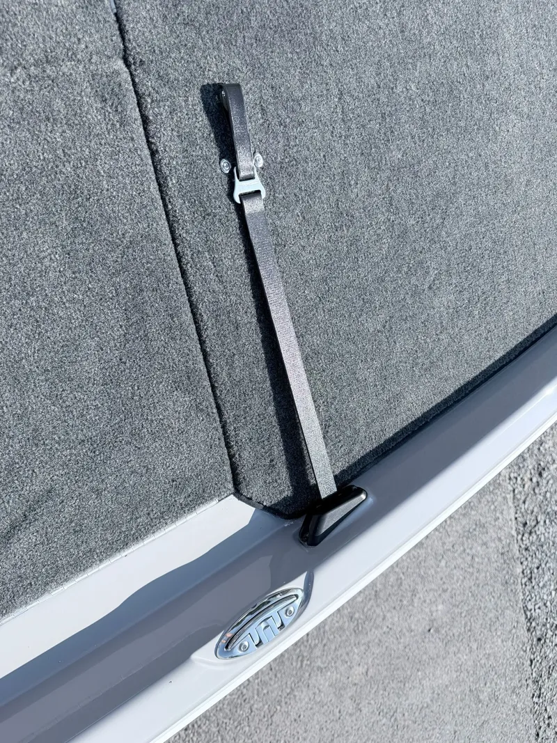Slide: The Image of Close-up of a boat deck with gray carpet and a black strap. - 35